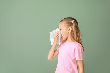 Little girl suffering from allergy on color background