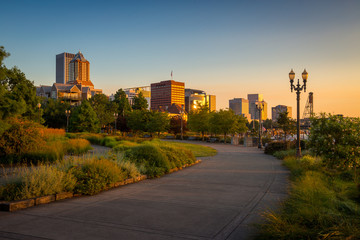 South Waterfront Park in Downtown Portland, Oregon, USA during beautiful sunrise with yellow glow and clear blue sky - obrazy, fototapety, plakaty