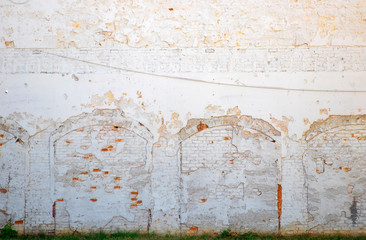 Bricked over archways with peeling paint in old wall