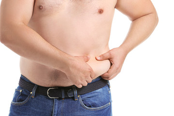 Overweight man touching his belly against white background. Weight loss concept