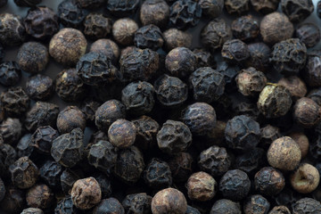 Macro image of black peppercorns revealing texture and pattern