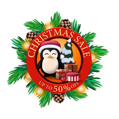 Christmas sale, up to 50% off, red round discount banner with Christmas tree branches, cones, bulbs and penguin in Santa Claus hat with presents