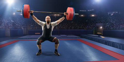 Male athlete squats with a barbell on a professional stadium. Stadium and crowd are made in 3d. - obrazy, fototapety, plakaty