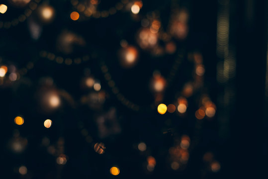 Lights of christmas tree blurred bokeh on dark background.