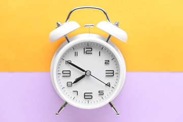 Alarm clock on color background