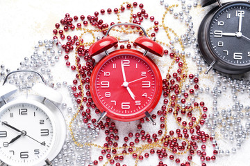Alarm clocks and decor on light background