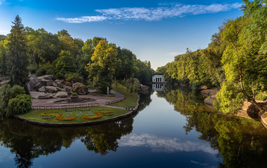 Fototapeta na wymiar Panoramic view of the pond Ionian sea, Flora Pavilion and Assembly square in the park Sofiyivka, Uman, Ukraine