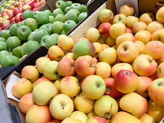 Assortment variety of apples different colors in a supermarket, organic whole vegetarian food in farm market