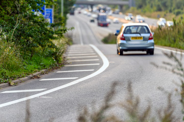 car moving towards uk motorway on junction exit in england