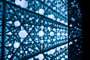 Small white lights in blue glass art installation