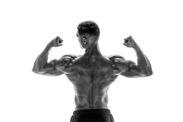 Tattooed Bodybuilder showing his back and biceps muscles isolated on a white background, personal fitness trainer. Strong man flexing his muscles