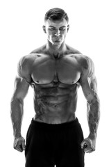 Fototapeta na wymiar Tattooed muscular super-high level handsome man posing in studio isolated on white background
