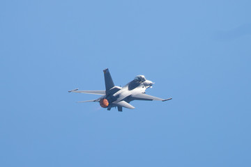 F-16 Fighting Falcon in a high-G maneuver, with afterburner  condensation trails at the wing