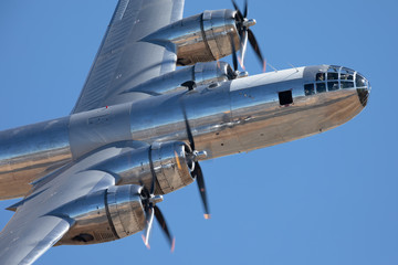 Very close side view of a rare WWII bomber (B-29 Superfortress) flying 