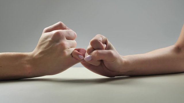 Close-up, adult couple hands of lovely couple hooking each other's little finger together ,pinky swear, pinky promise concept 4k