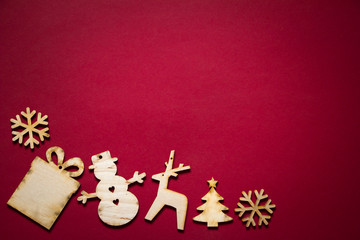 Christmas backgrounds, various wooden decor on a red background, selective focus