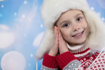 Smiling girl in the winter look. Christmas concept.