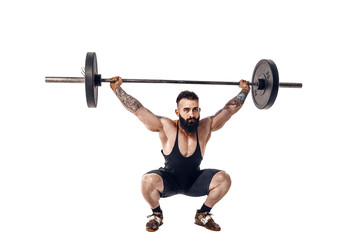 The technique of doing an exercise of deadlift with a barbell of a young muscular strong tattooed bearded sports men on a white studio background. Isolate