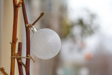 New Year or Christmas background, close-up of white Christmas balls on a blurred background, selective focus