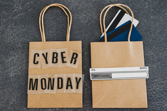 cyber monday shopping bag next to another one with payment cards and progress bar loading