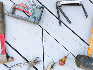 Flat Lay of Old Tools Against a Painted Wooden Background with Space for Text