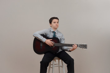 Middle school boy playing guitar