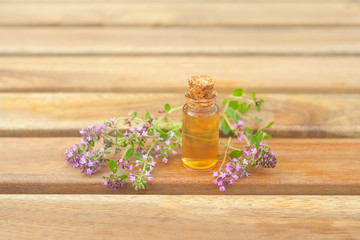 thyme essential oil in  beautiful bottle on table