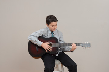 Middle school boy playing guitar