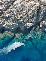 blue sea and stone coast drone shot