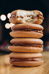 Close up Traditional chocolate and Pumpkin Whoopie pies filled made with vanilla cream cheese frosting cream