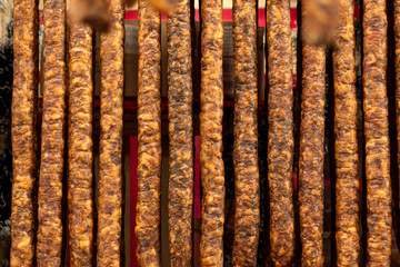 Hanging sausages in smokehouse for sale at the winter Christmas market