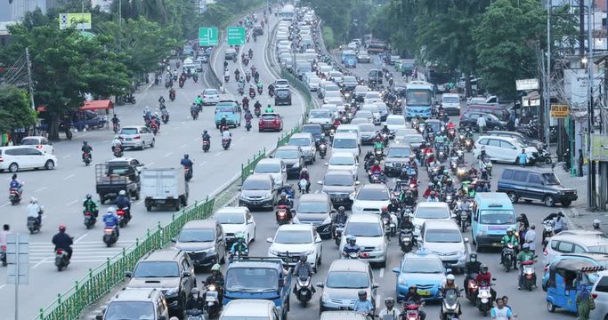 JAKARTA, Indonesia - November 27, 2019: Aerial view of undisciplined cars and motorcycles driver in traffic jam on highway. Shot in 4k resolution