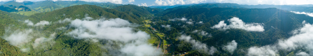 Aerial bird eye view panorama stunning landscape of mountain under sunlight in mist and fog...