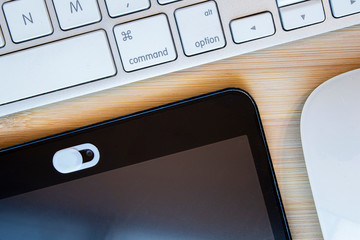 A White Color Camera Privacy Cover. Slide Webcam. Cover for an electronic device with a keyboard on...