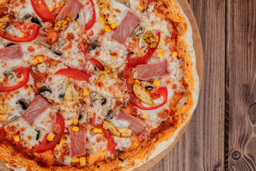 Pepperoni Pizza with Mozzarella cheese, Ham, Tomatoes, pepper, Spices . Italian pizza.