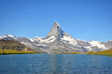 Gorgeous Matterhorn and Stelilisee Lake with clear blue skies (and hikers enjoying the view), Zermatt, Switzerland