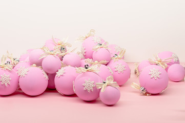 Flat lay, Christmas spheres, pink and white background, Xmas and New Year holiday