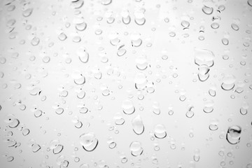 Raindrop water dew drop on glass wet white gray blue background.