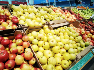 Fresh apples of various sorts are sold in the supermarket