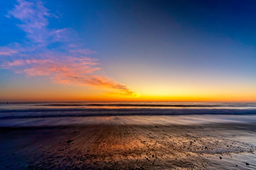 Fototapeta na wymiar Sunset on Beach with pebbles, long exposure 