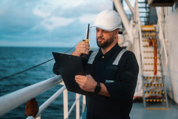 Marine Deck Officer or Chief mate on deck of offshore vessel or ship , wearing PPE personal...