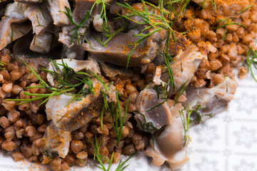 Stewed turkey stomachs with vegetables and buckwheat in a bowl