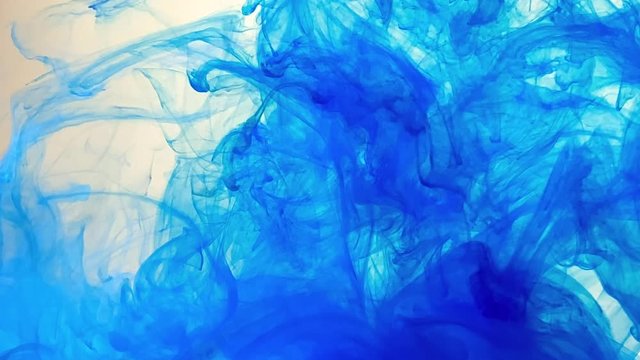 Marine blue abstract background. Stylish background. Blue watercolor ink spreads beautifully in water. The smooth movement of acrylic ink on a white background.