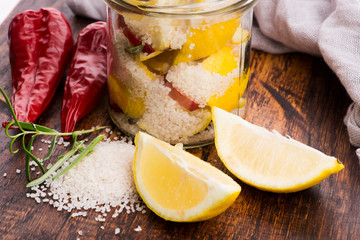 Preserved Lemons with salt on a wooden board