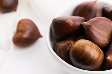 Bowl of chestnuts on a white background