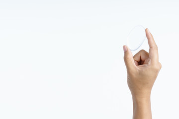 Hand holding transparent cosmetic silicone puff