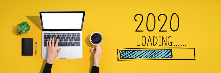 Loading new year 2020 with person using a laptop computer