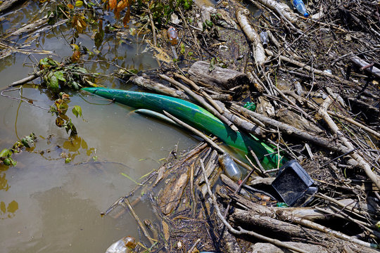 Plastic From Water And Soda Bottles, A Fast Food Container And A Kayak Litter The Cumberland River Just Above The Cumberland Falls Contributing To The Global Micro Plastics Pollution 