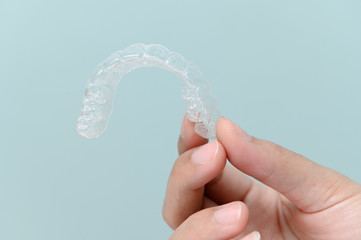 Woman show orthodontic silicone trainer. Mobile orthodontic appliance for dental correction. tooth...