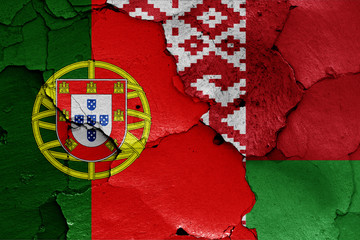 flags of Portugal and Belarus painted on cracked wall
